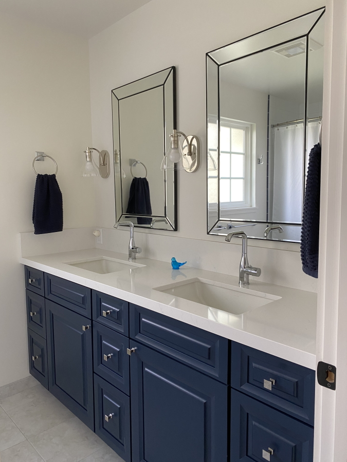 Custom blue bathroom vanity with dual mirrors